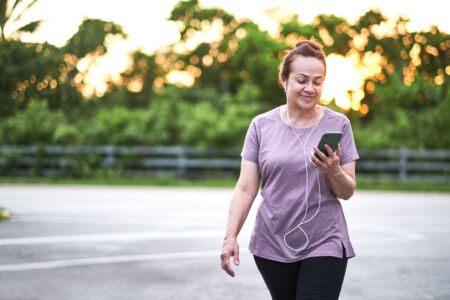 Mature woman walking at sunset