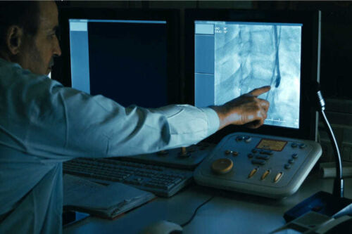 Doctor monitoring injection process into blood vessels