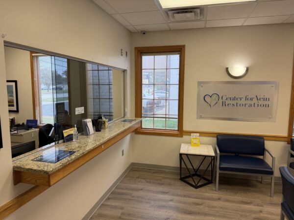 Interior photo of the Salem, New Hampshire location of center for Vein Restoration showing the outside of the building  Interior photo of the Albuquerque, New Mexico location of center for Vein Restoration showing the reception desk