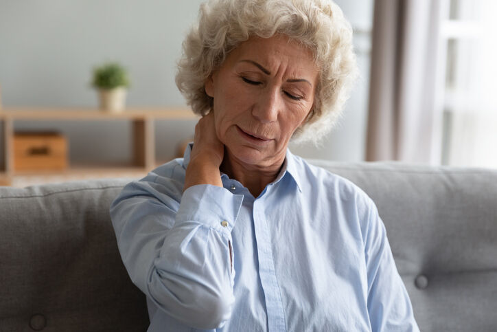 Woman on couch with neck pain
