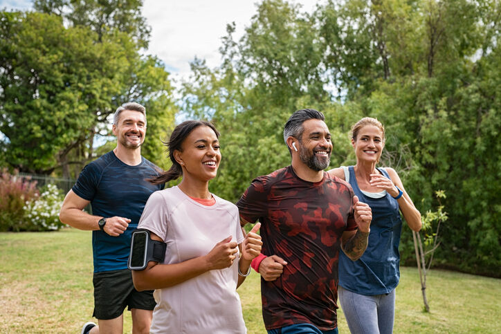 4 adults running outside