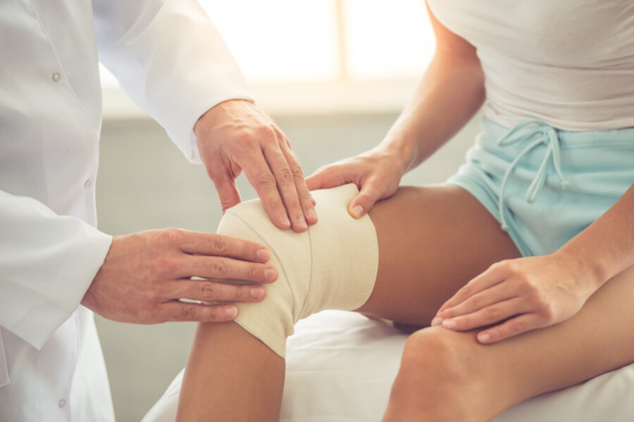 Woman getting knee examined