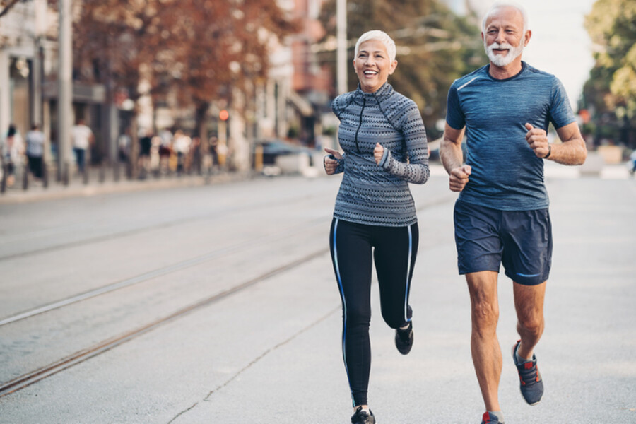 Senior man and woman jogging